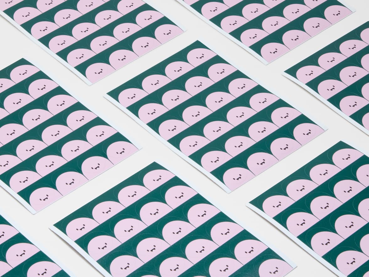 A collection of round coated stickers with animated faces printed on it.