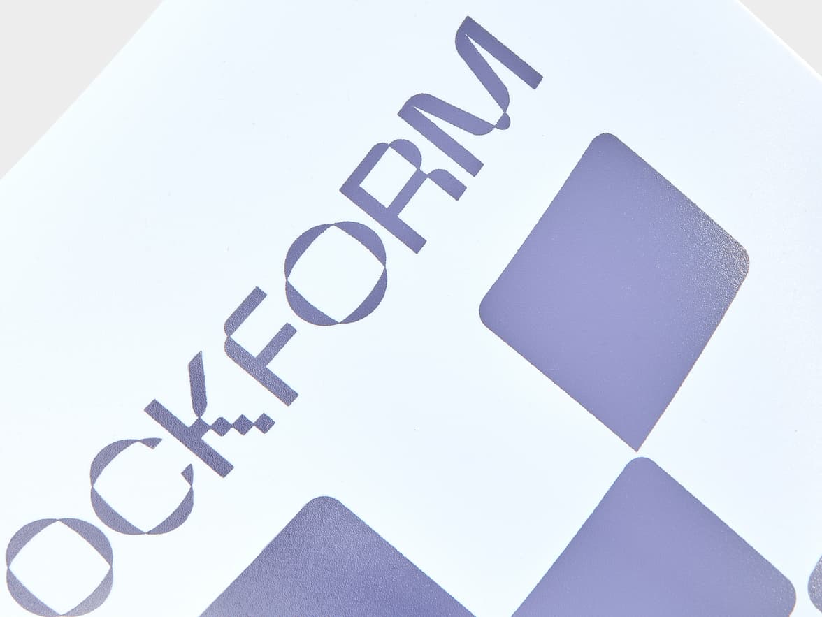 A white notebook with purple branding that reads "OCKFORM" and features purple checkered patterns.