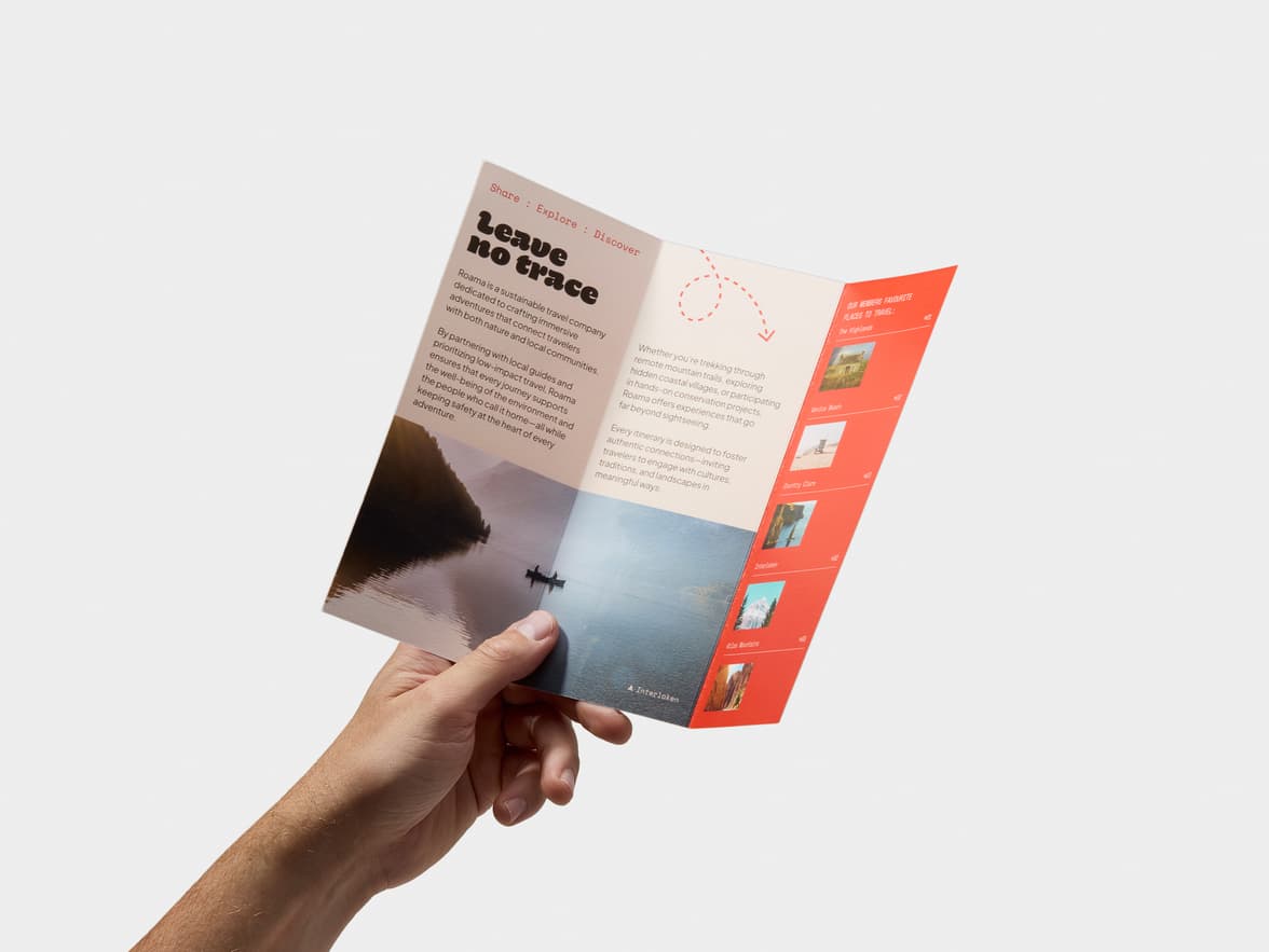 Open travel brochure held by a person, showing sustainable travel info and destinations.