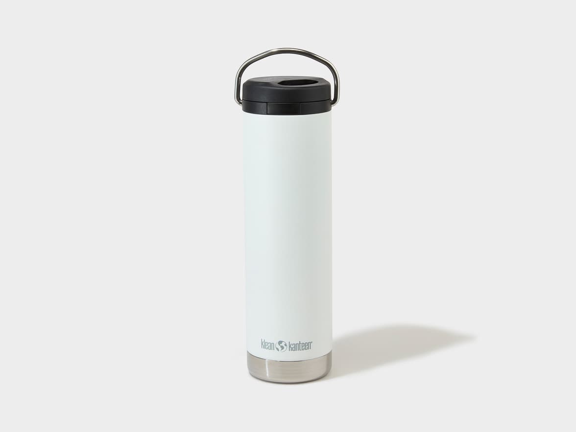 White Klean Kanteen insulated bottle with a black lid and a silver handle.