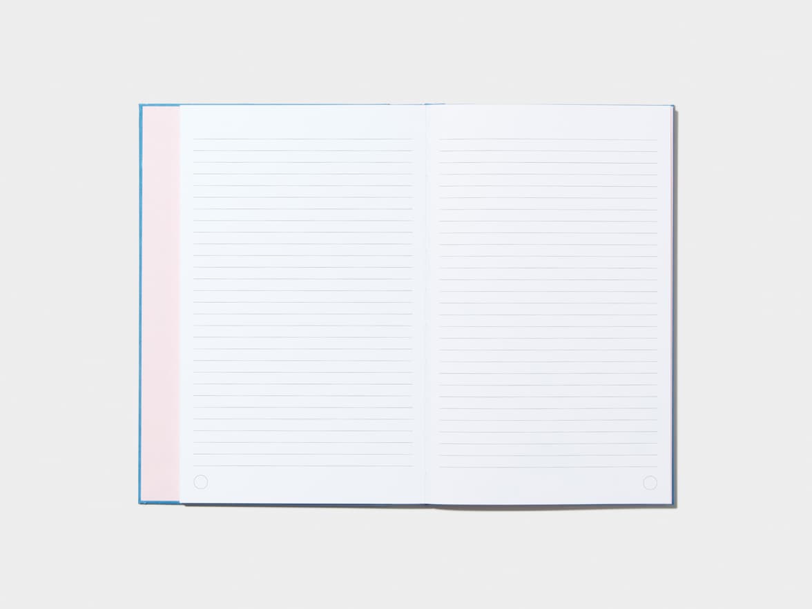 An opened Sky BlueHardcover Notebook with lined pages 