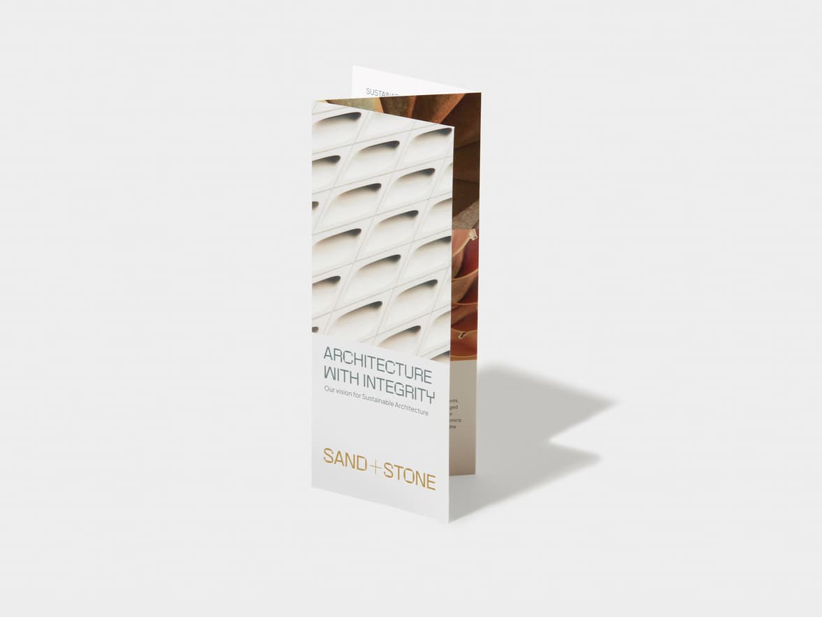 A standing trifold brochure for Sand + Stone, featuring an architectural pattern and text about sustainable architecture.