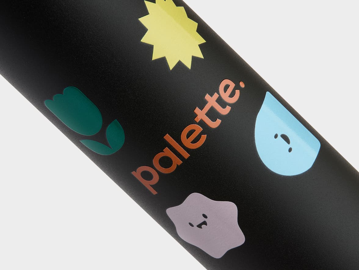Black bottle with "palette." branding and colorful designs including a yellow star, green flower, blue droplet, and a purple blob.
