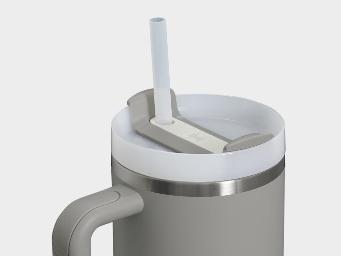 Top view of a grey tumbler with a white lid, clear straw, and a grey handle.