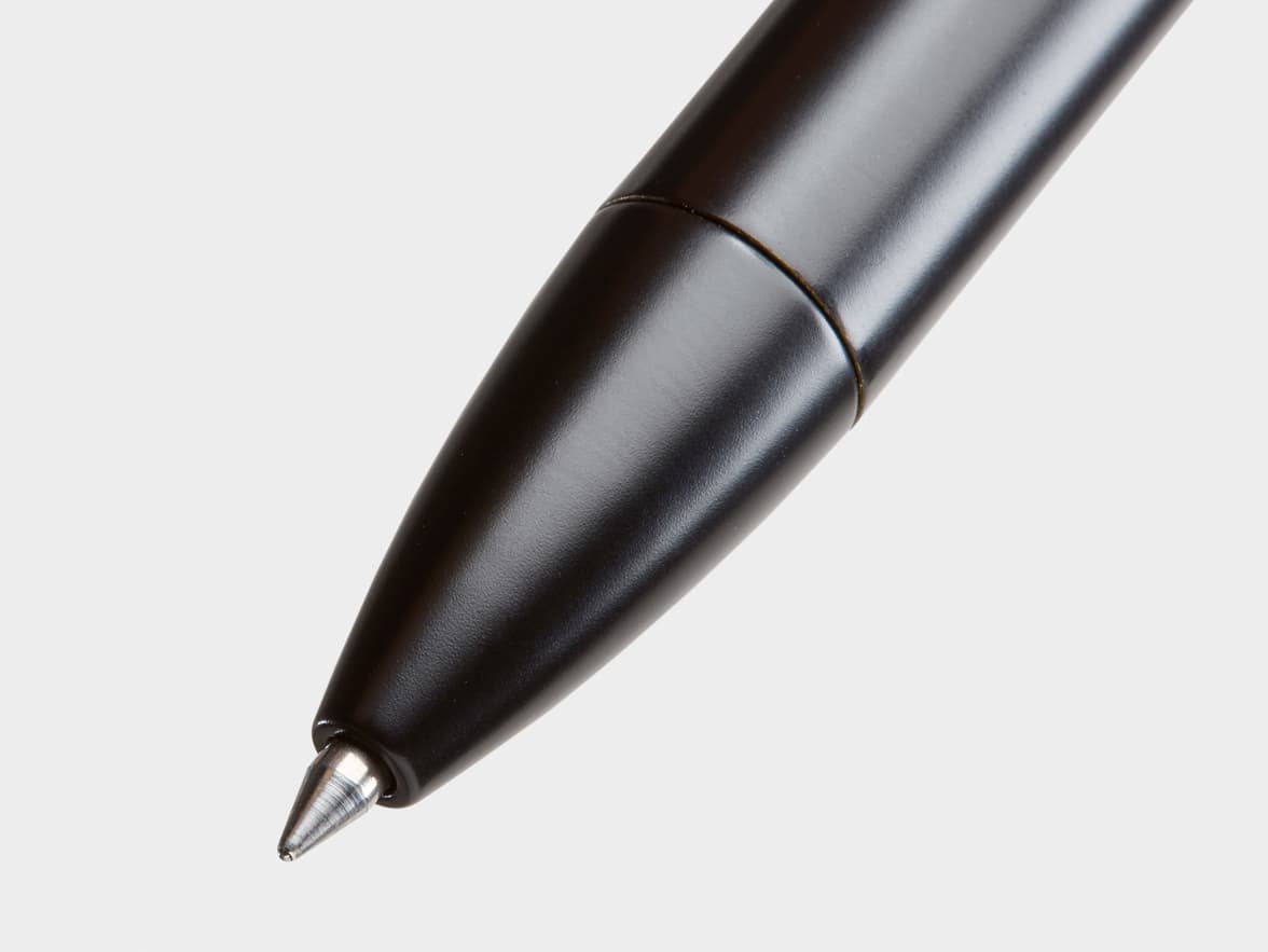 Close-up of a black matte pen tip with a silver metallic ballpoint.