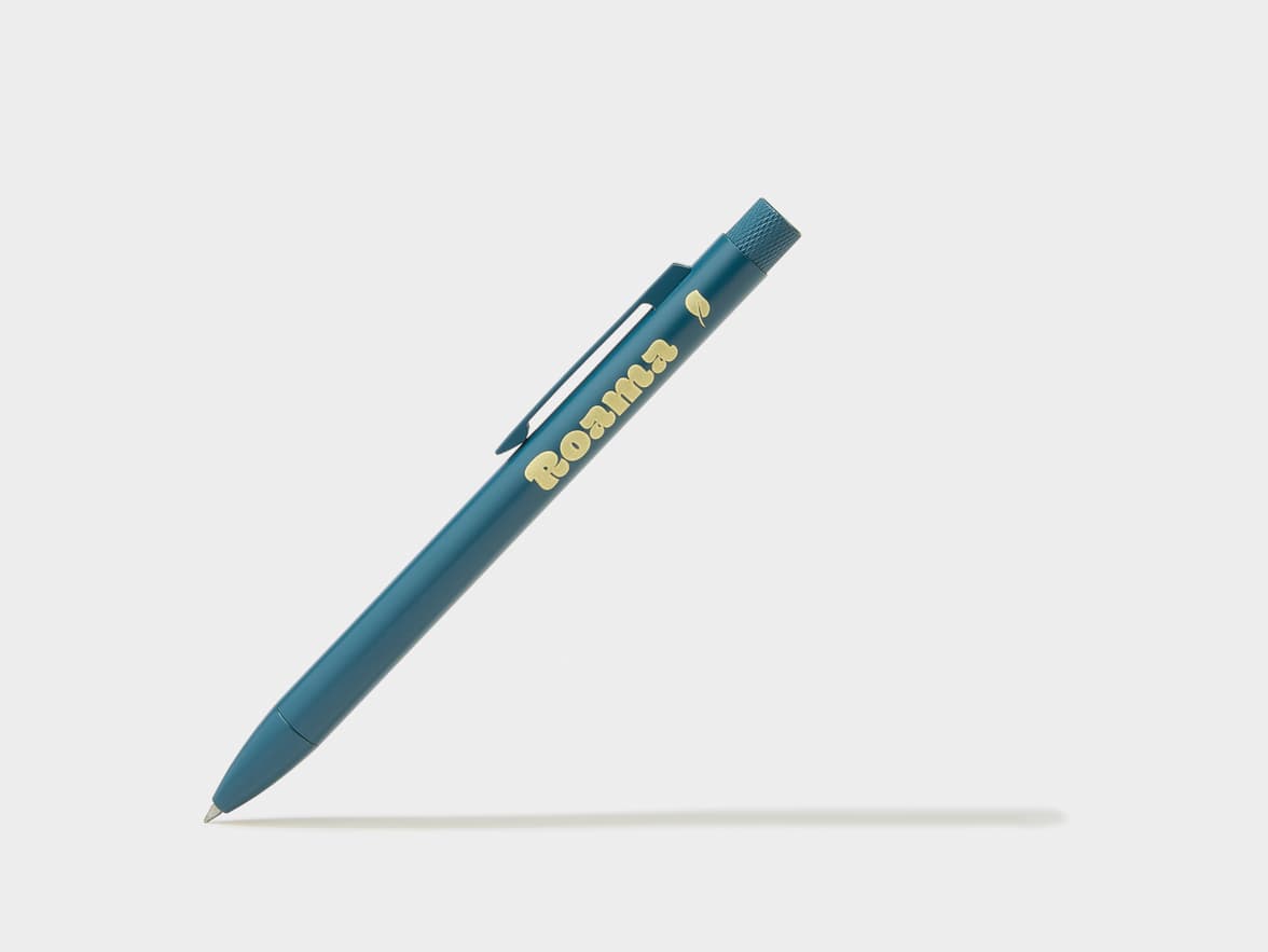 A teal pen with the brand name 'Roama' and a leaf icon in gold.