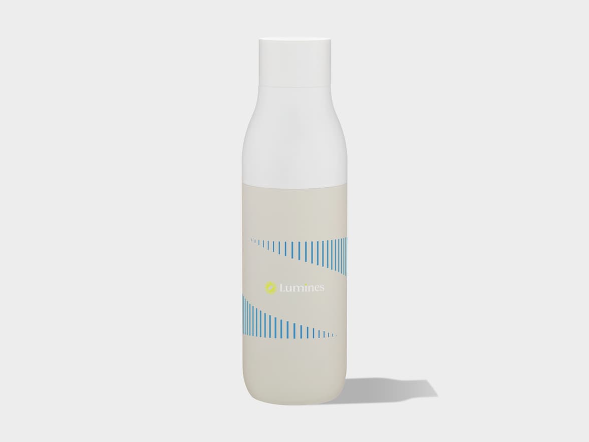A white bottle with a beige label featuring the "Lumines" logo and a design of varying blue vertical lines is shown on a light grey background, casting a shadow to its right.