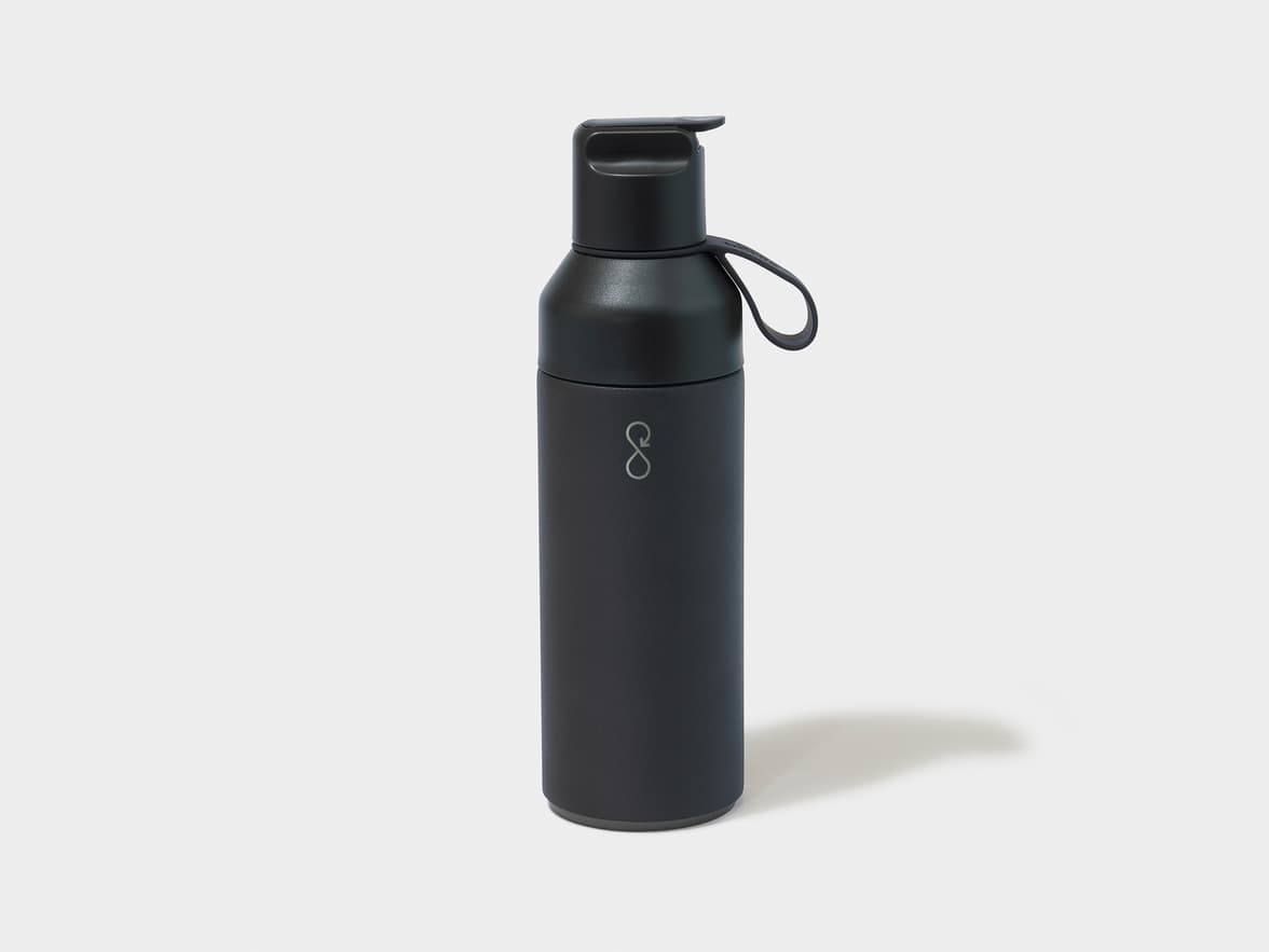 A black water bottle with an infinity symbol logo on its side, sitting on a white background.