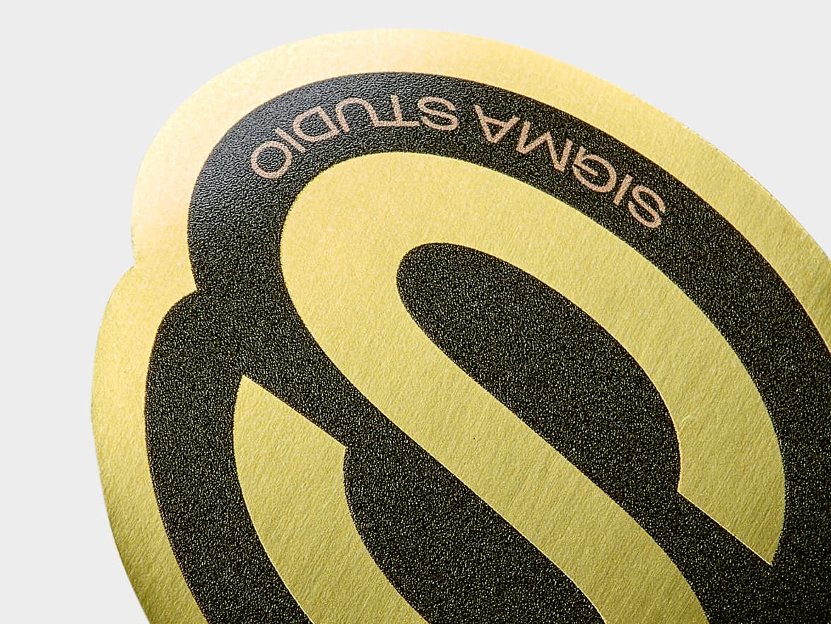 A close up of a customized gold metallic sticker.