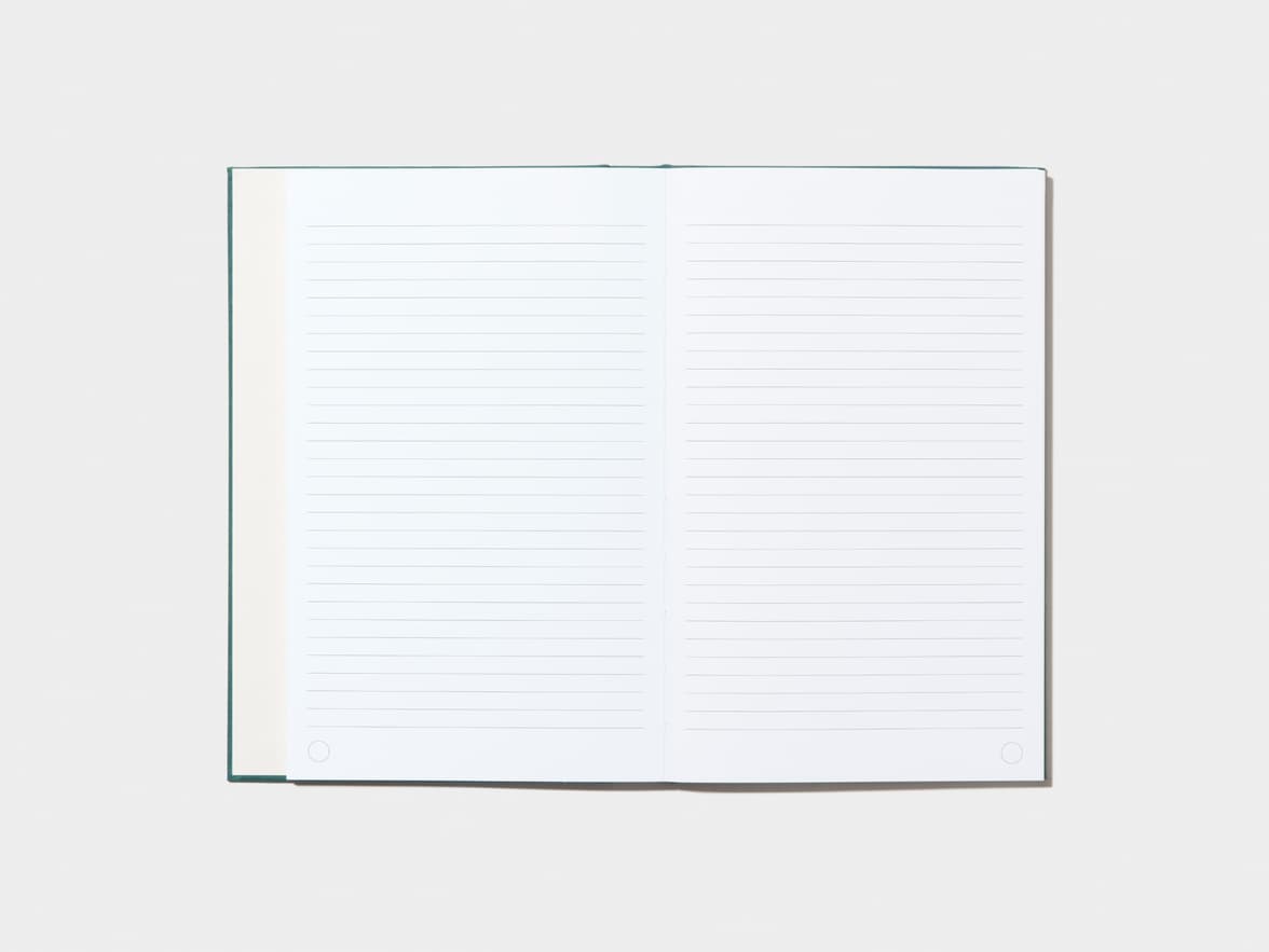 An opened Alpine Green Hardcover Notebook with lined pages 
