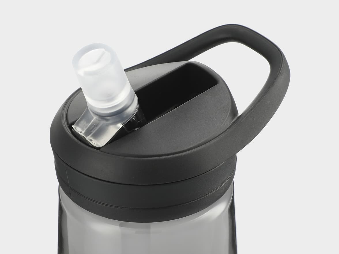 Close-up of the top of a dark grey water bottle with a black handle and a clear pop-up straw.