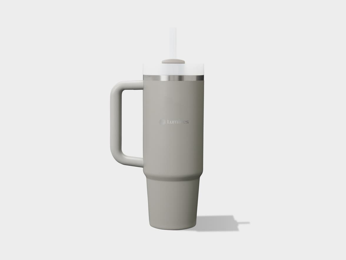 A light gray insulated tumbler with a handle, clear lid, and straw.