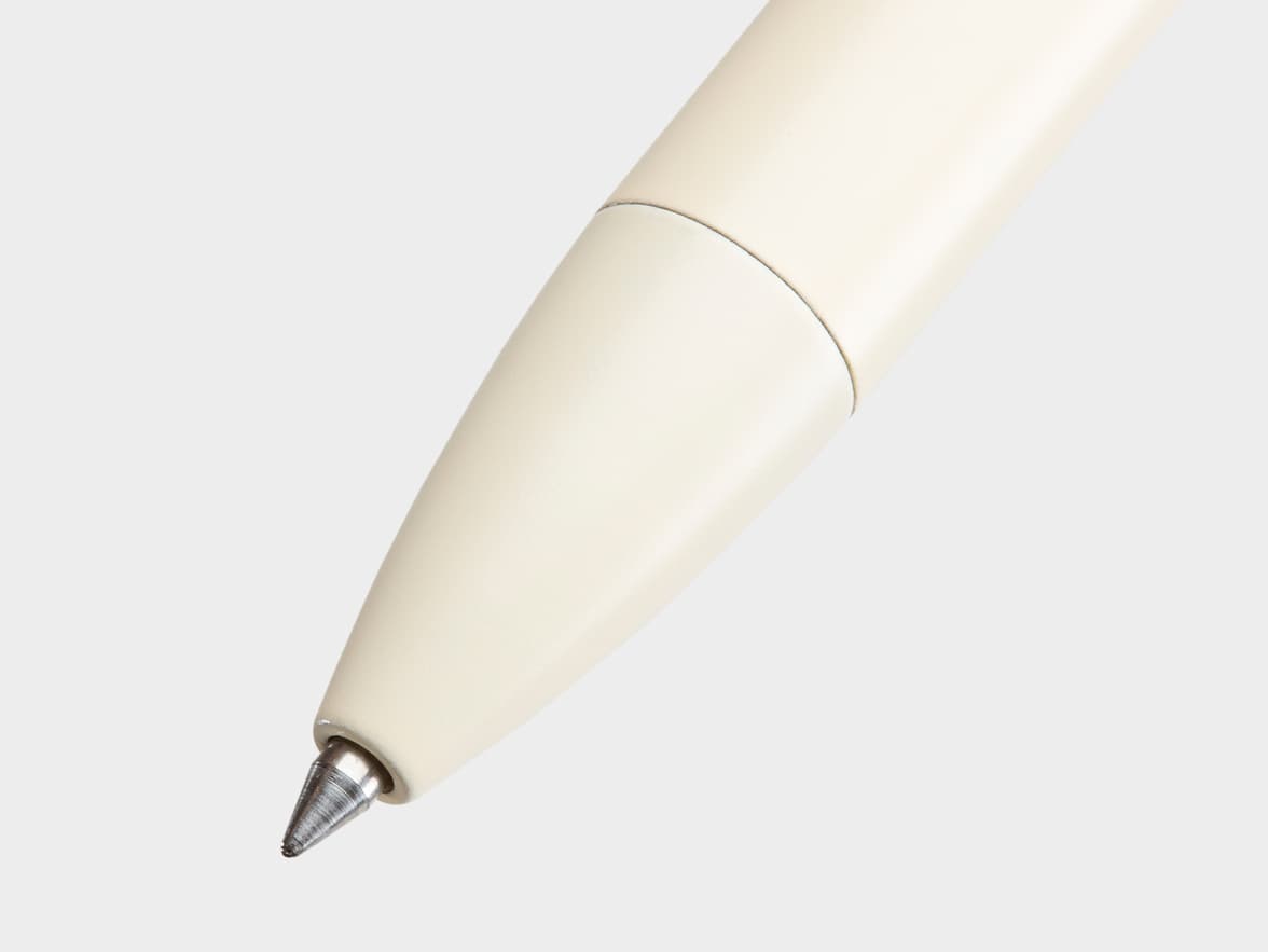Close-up of the tip of an off-white pen.