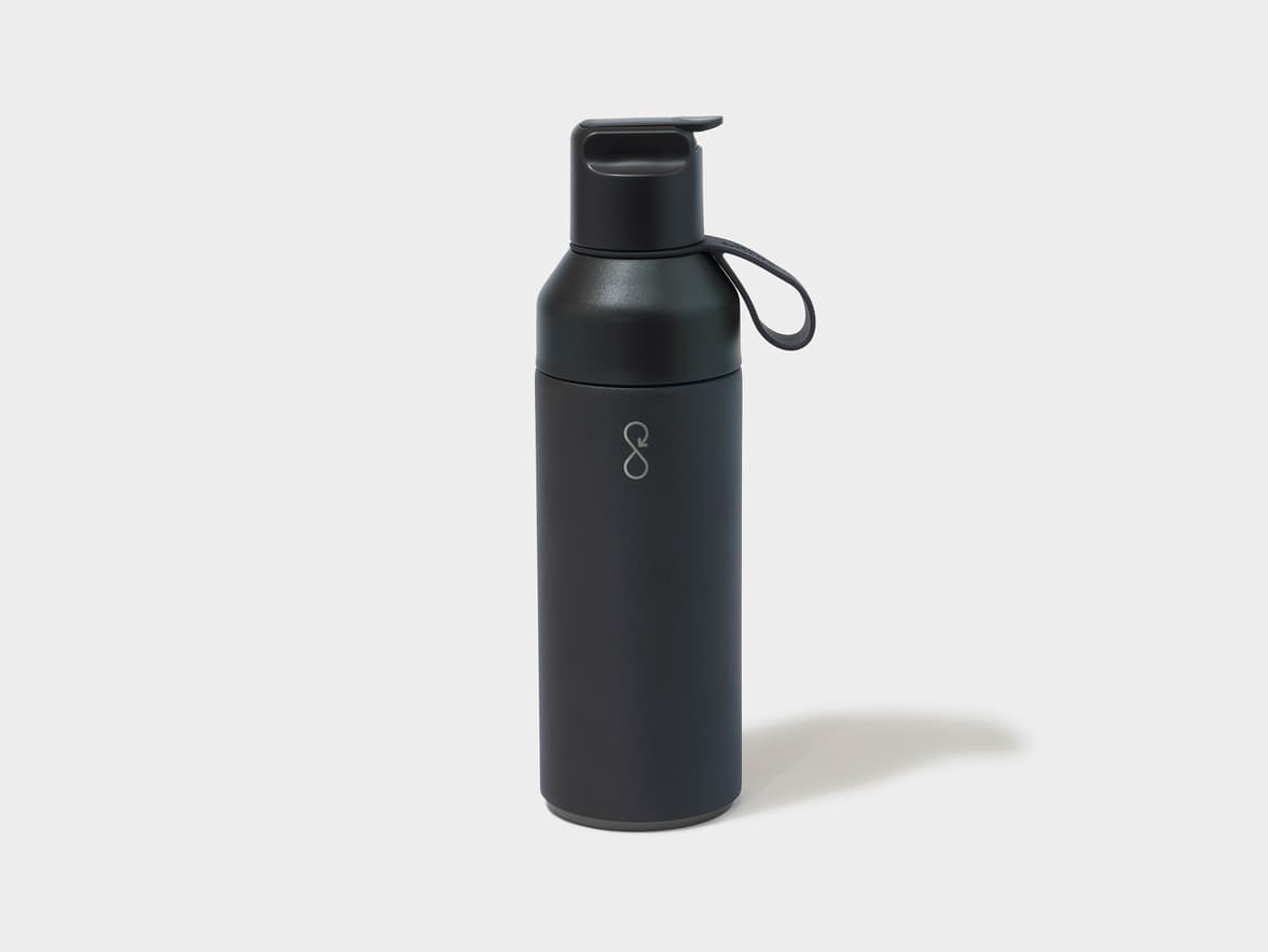A black matte water bottle with a flip-top lid, a carrying loop, and a silver stylized loop logo.