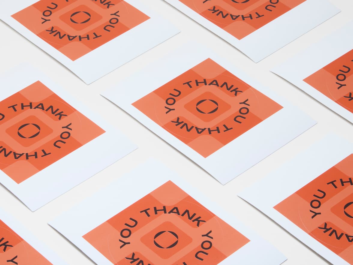 A collection of large orange customized round coated stickers.