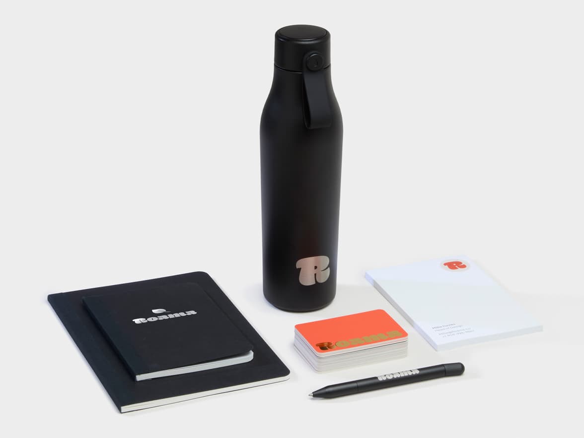 Collection of Branded Merchandise products including a black water bottle, a pen and notebooks.