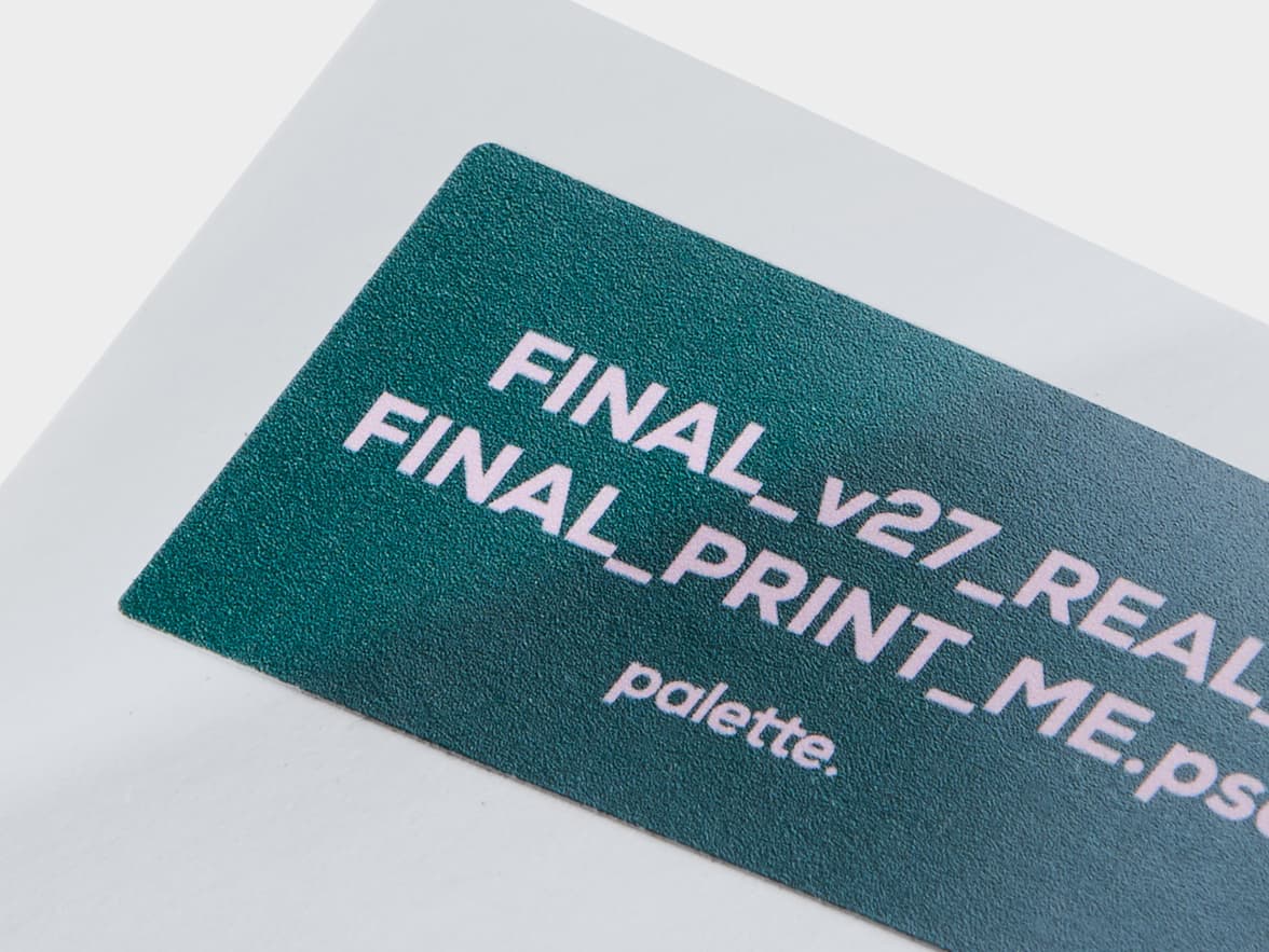 A close up image of a rectangular coated sticker with green and purple customization.