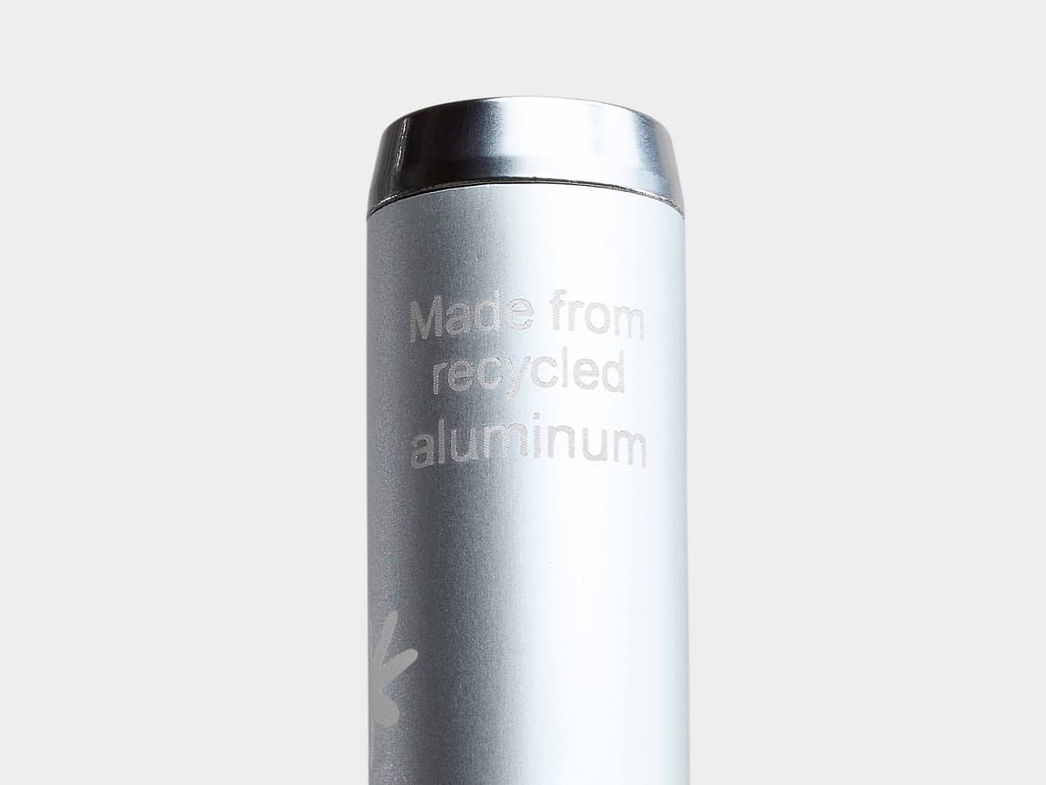 A silver metallic pen with the engraved text "Made from recycled aluminum" and a subtle leaf-like logo.