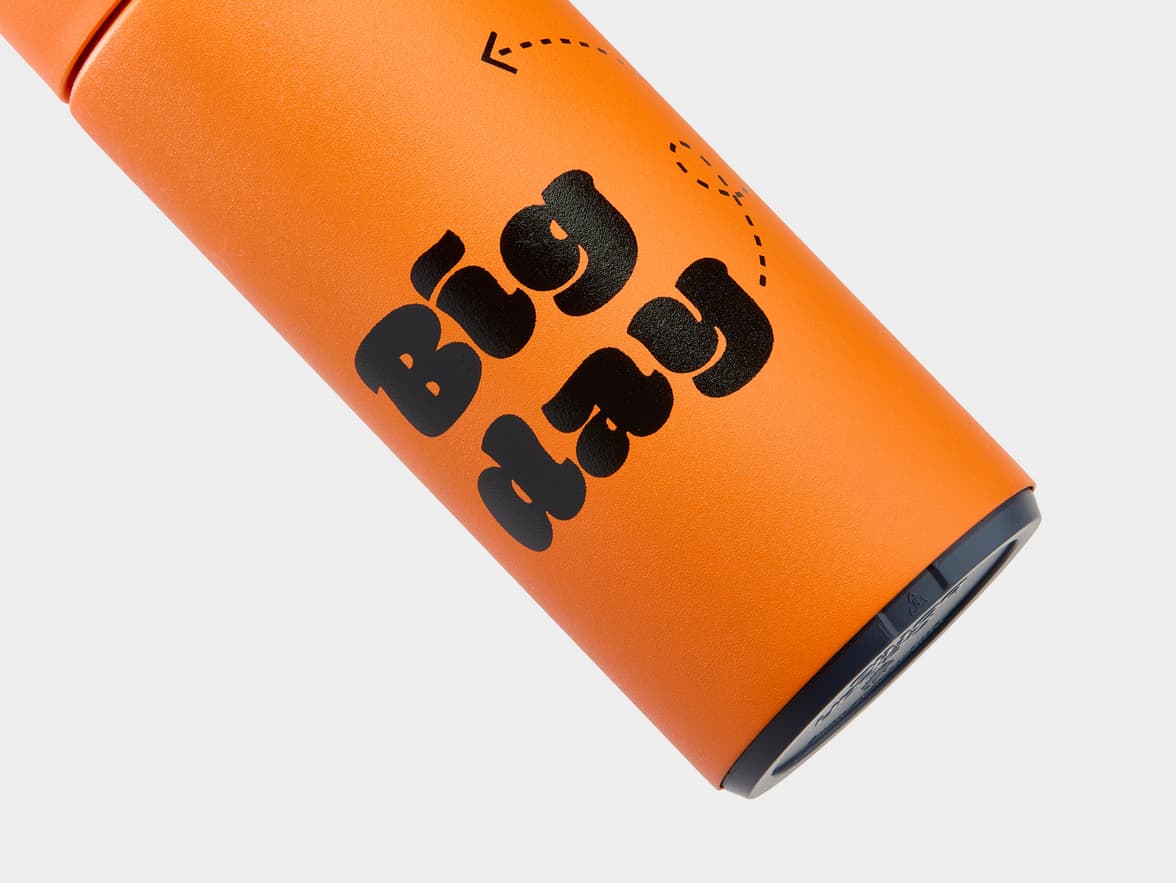 Orange textured bottle with "Big day" branding and an arrow graphic.