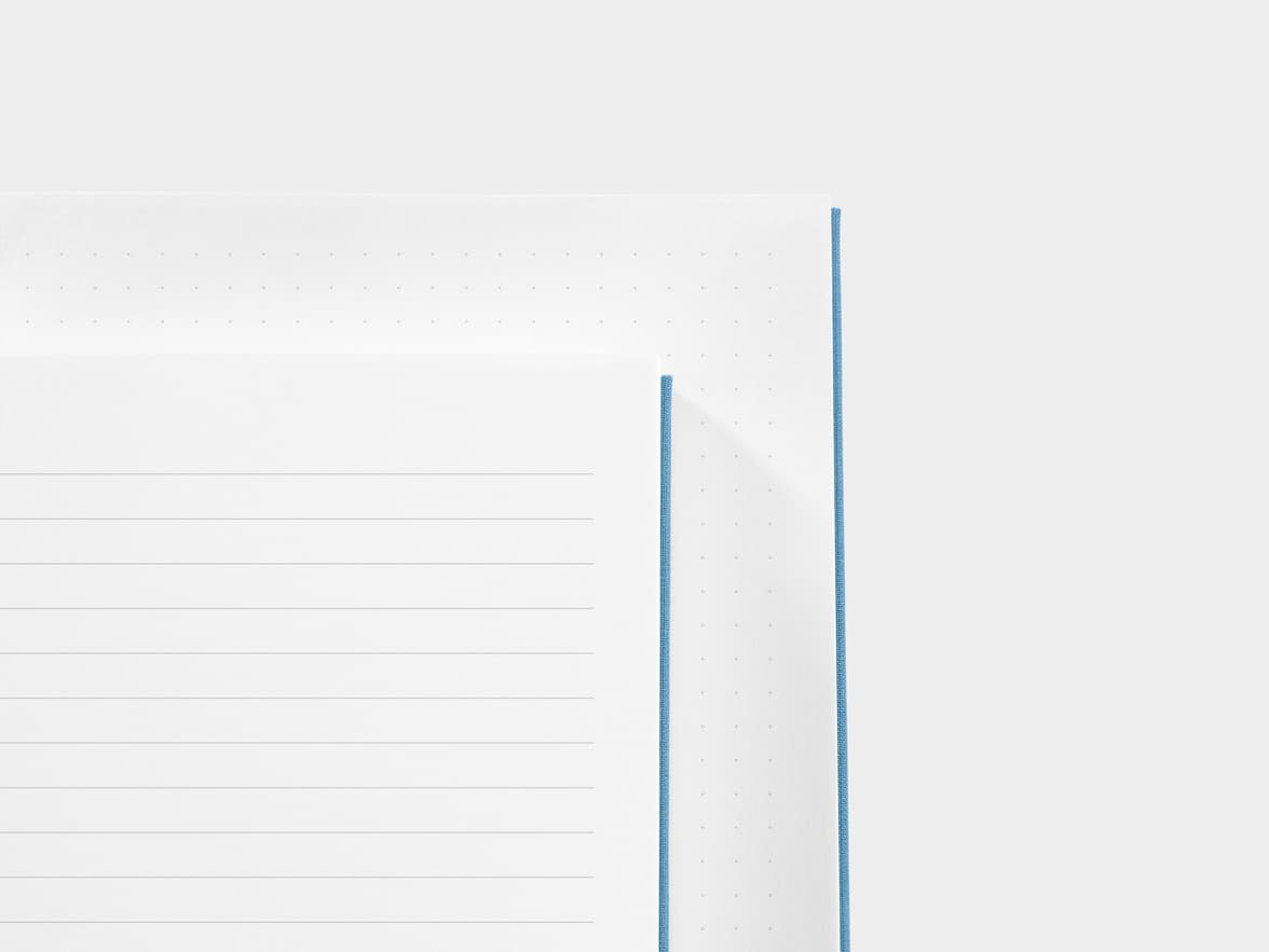 A close up of a dotted paper and a lined paper next to each other 