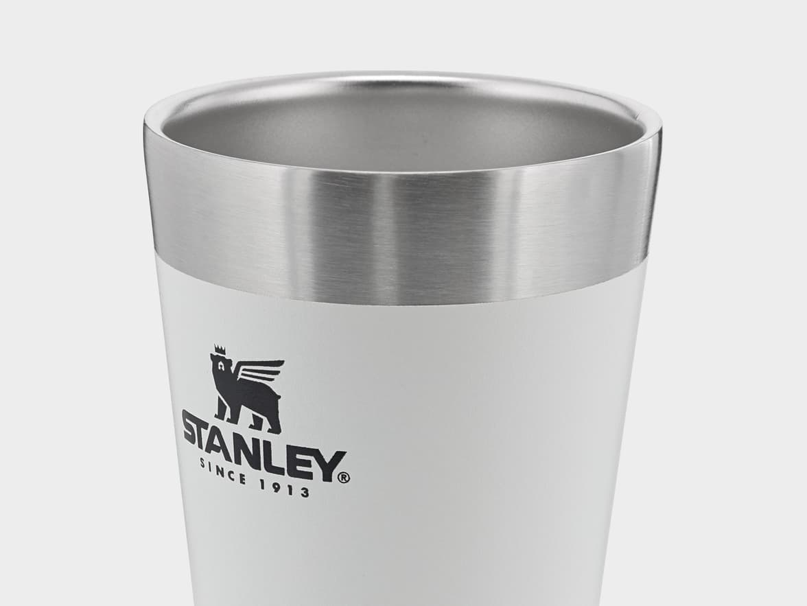 White Stanley tumbler with silver rim and logo.