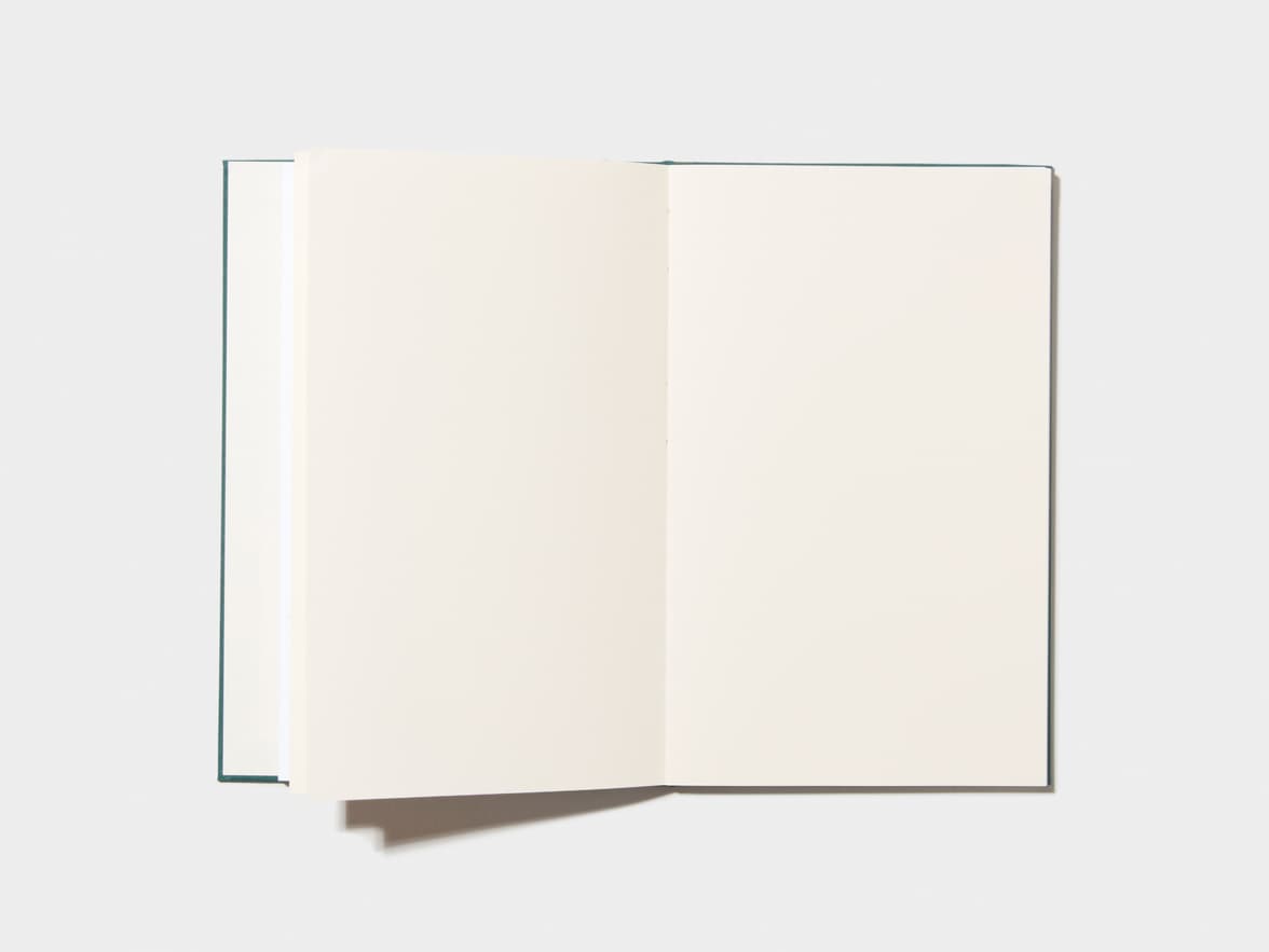 An opened Alpine Green Hardcover Notebook with empty pages 