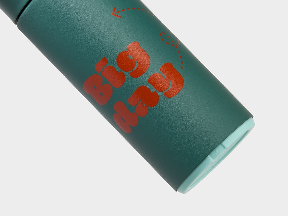 Dark teal-green bottle with "BIG MOOD" branding in red lettering.