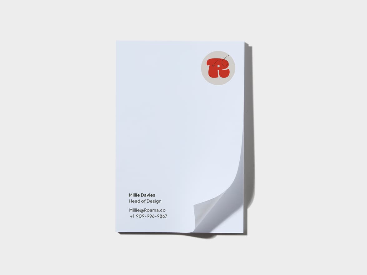 Top down shot of the Small MOO Notepad with Roama custom branding and the first page lifting