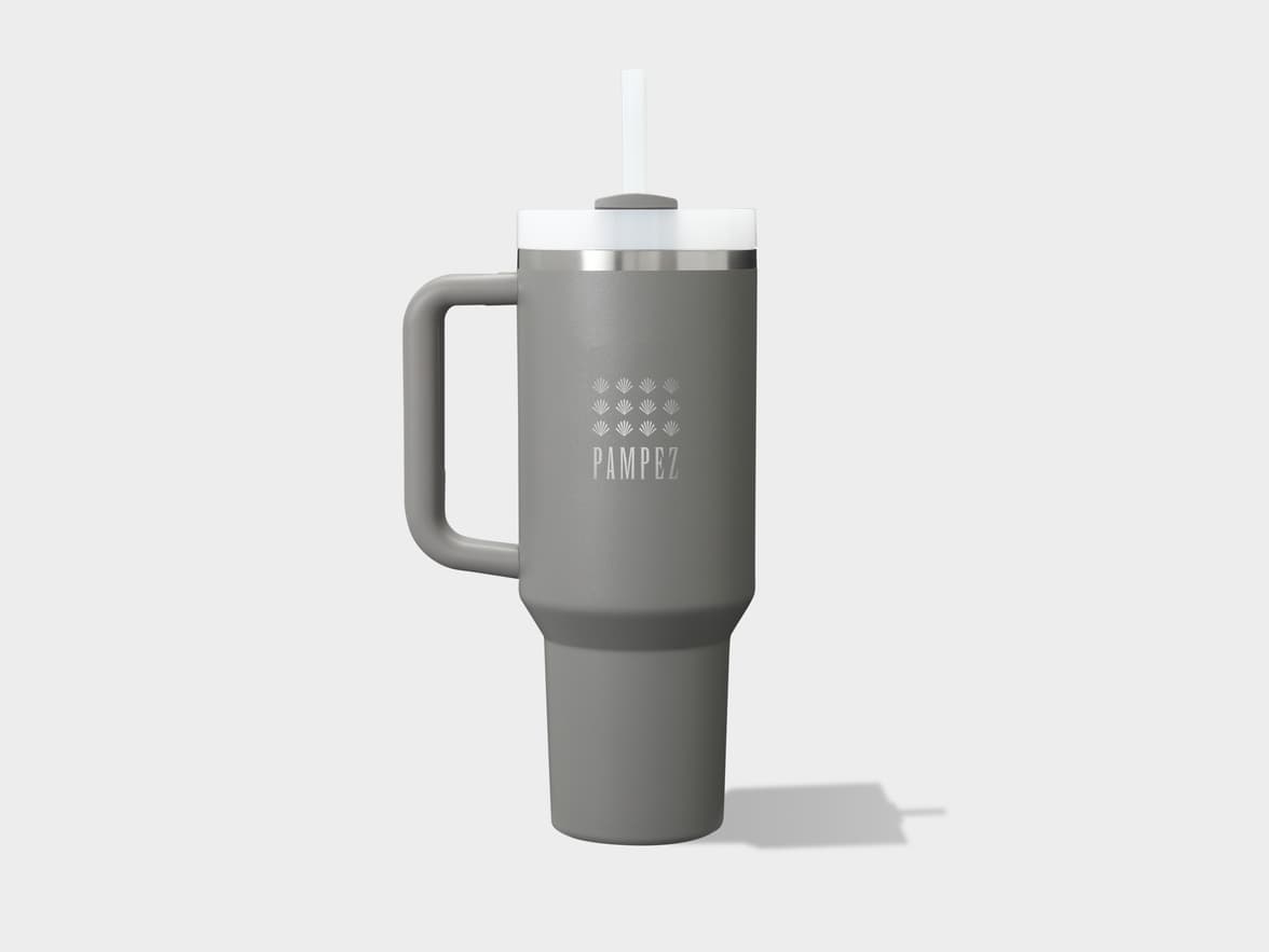 A gray travel mug with a handle, white lid, and straw, featuring a "PAMPEZ" logo and plant symbols.