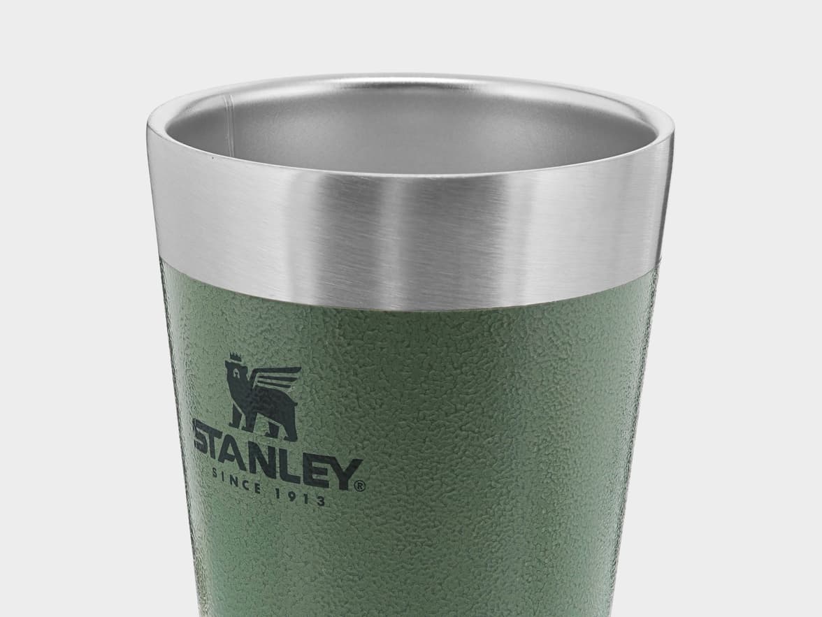 Green textured Stanley tumbler with a stainless steel rim and logo.