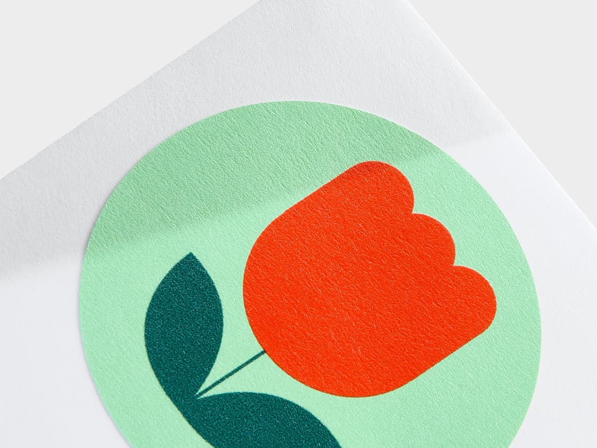 A close up image of a customized round matte paper sticker in size 2 inch.