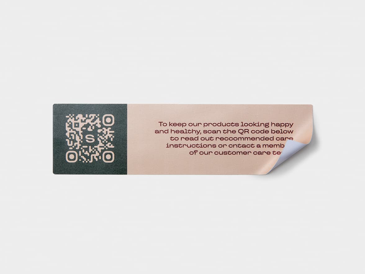 A rectangular coated sticker with customization and a QR code printed onto it.