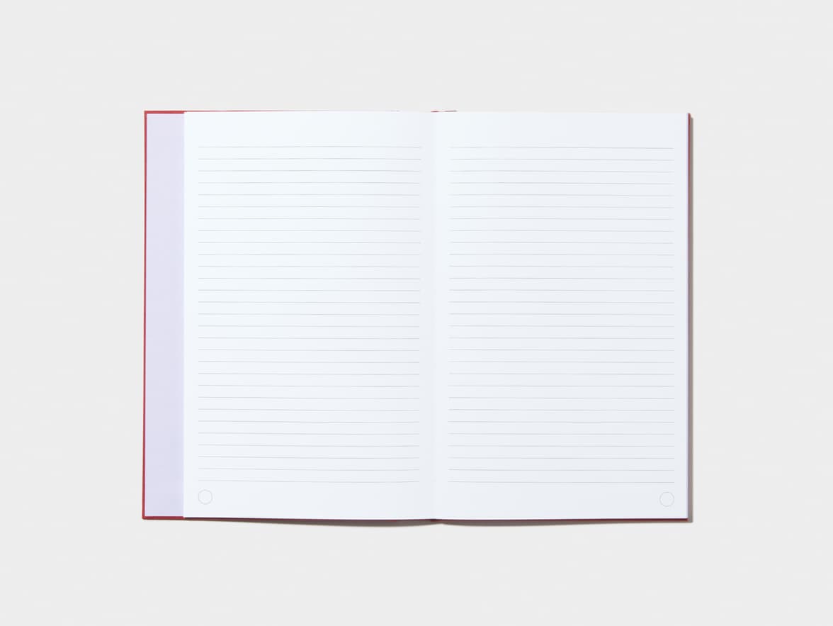 An opened Wine Red Hardcover Notebook with lined pages 