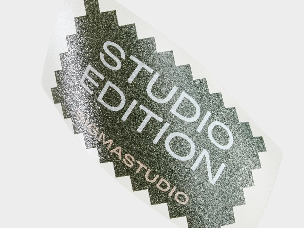 A close up of a customized clear rectangular sticker with the words 'Studio Edition' printed on it.