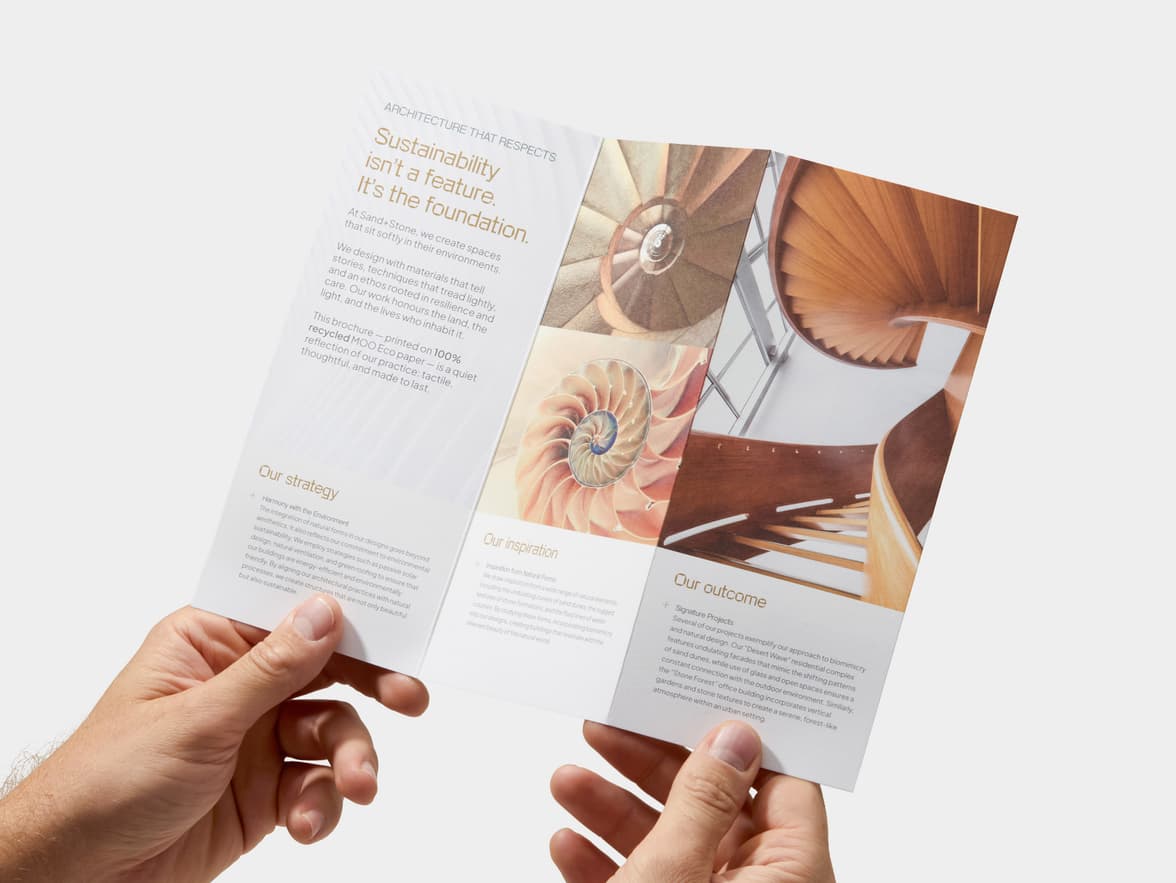 A pair of hands holding open a Z-Fold Eco Brochure.