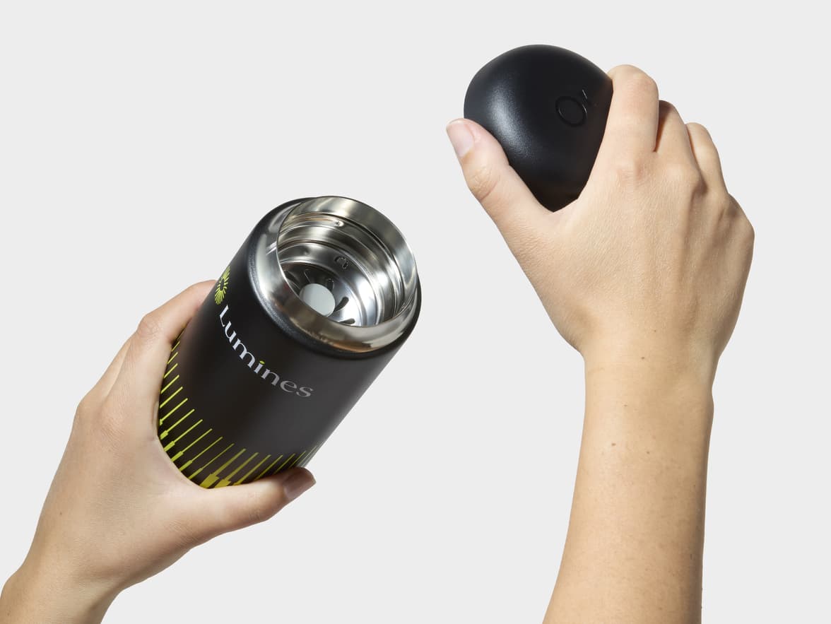 Hands Removing Lid From Matte Black Fellow® Carter Move Mug With 360 Wrap Printing Customisation