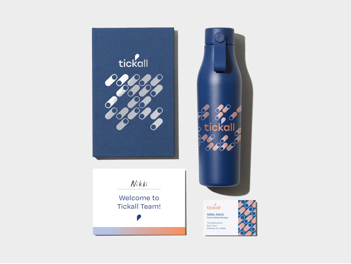Midnight Blue flyer in top left corner. Hardcover Notebook with White Foil Pattern in top right corner. A business card with green details in bottom left corner. An Midnight Bluewater bottle with coloured pattern in bottom right corner.  