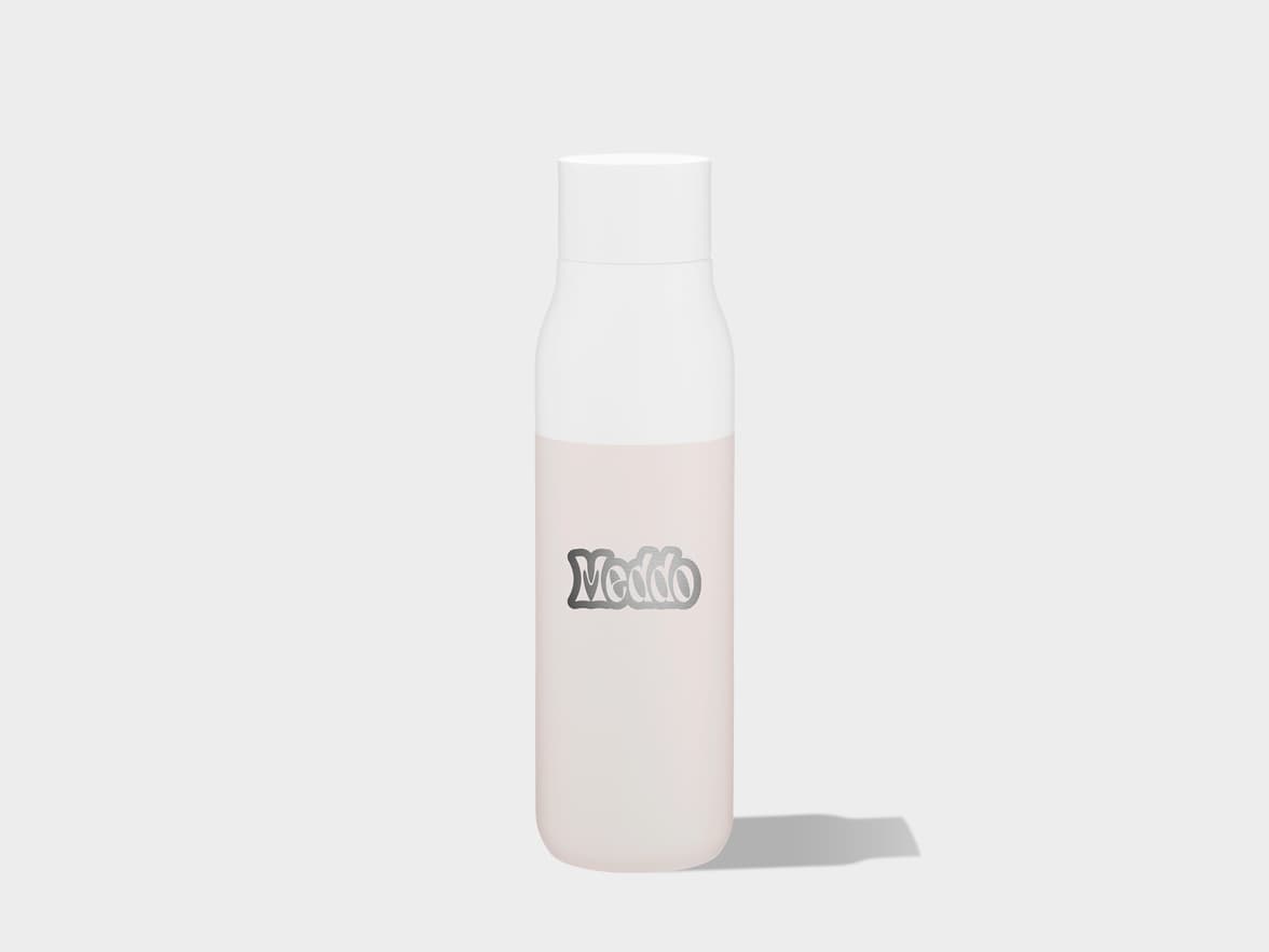A tall, slender bottle with a white cap and a pale pink body, featuring a metallic silver "Meddo" logo on the front, stands upright on a light surface with a subtle shadow extending to the right.