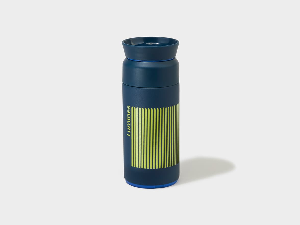 Dark blue flask with Lumines branding and vertical lime green stripes.