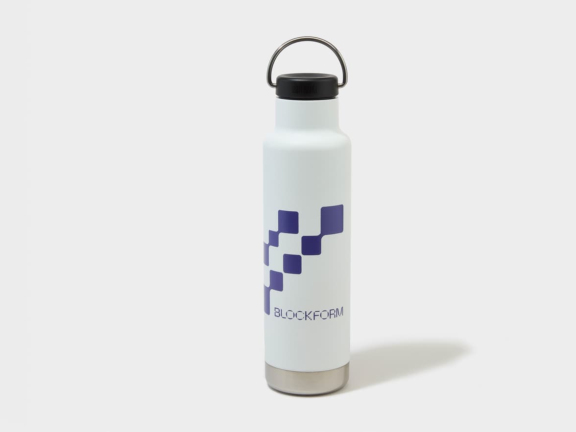 White bottle with a black cap, metal handle, and metal base, featuring a purple checkered pattern and "BLOCKFORM" text.