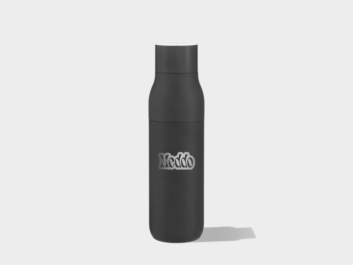 A dark gray water bottle with a silver "Meddo" logo stands upright on a light gray background, casting a shadow to its right.