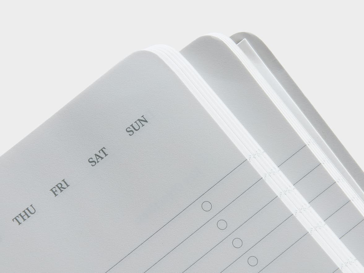 Corner shot of the lined and dated pages of the Karst Stone Paper Pro Series Softcover Notebook