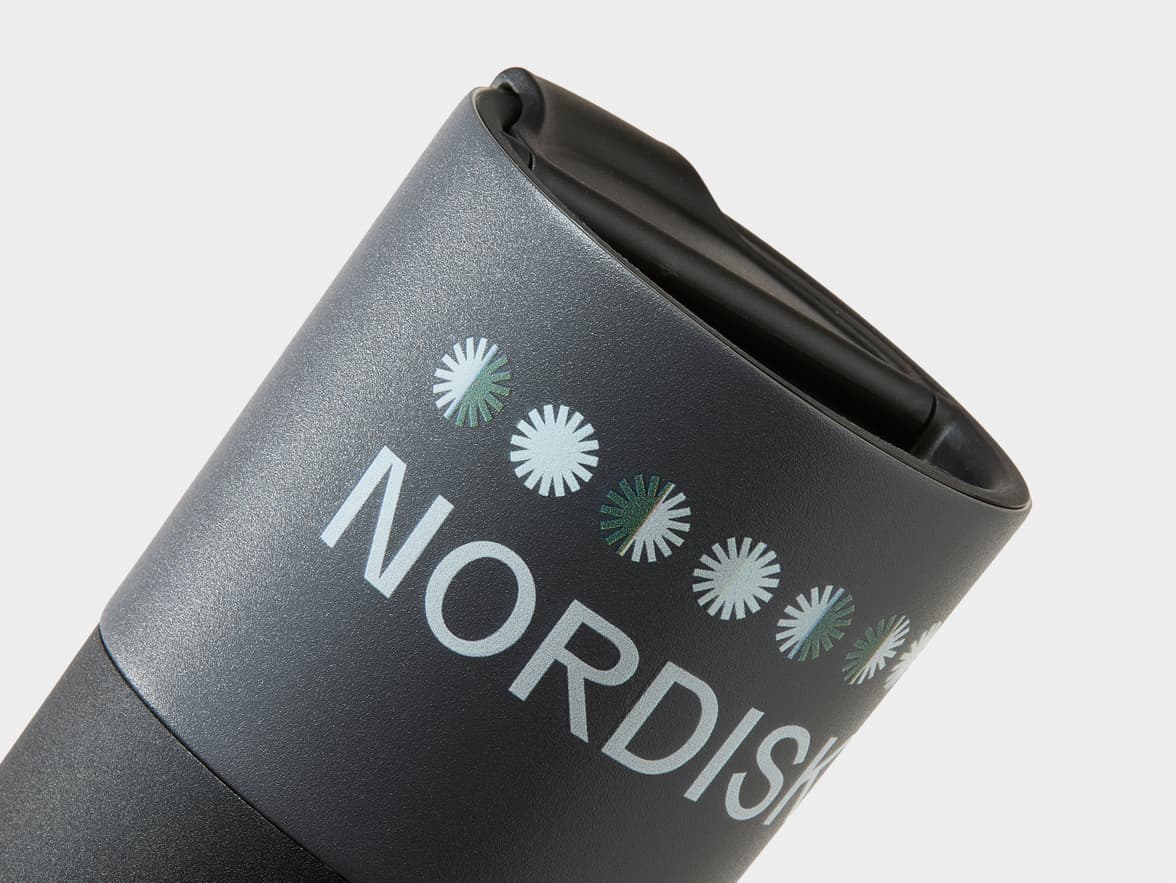 Dark gray textured tumbler with "NORDISK" branding and snowflake designs.