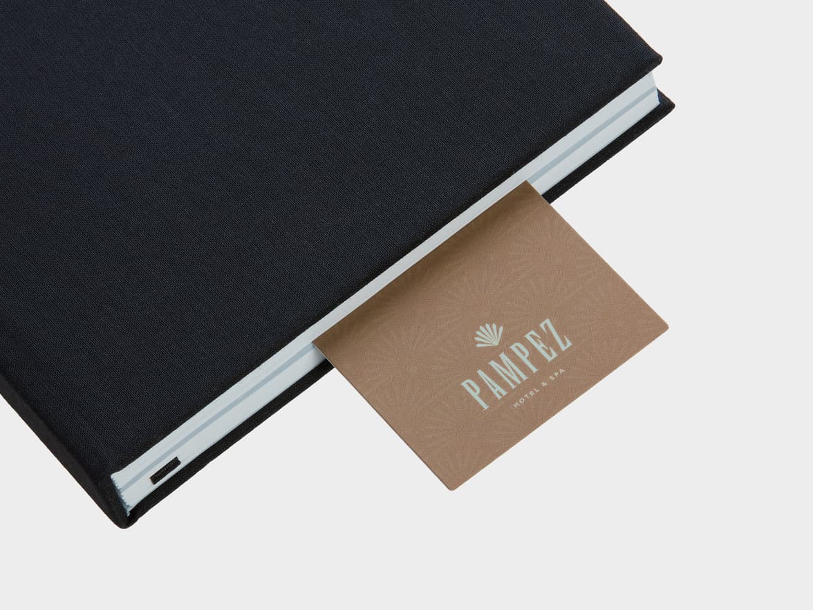 Soft touch bookmark sticking out of book.