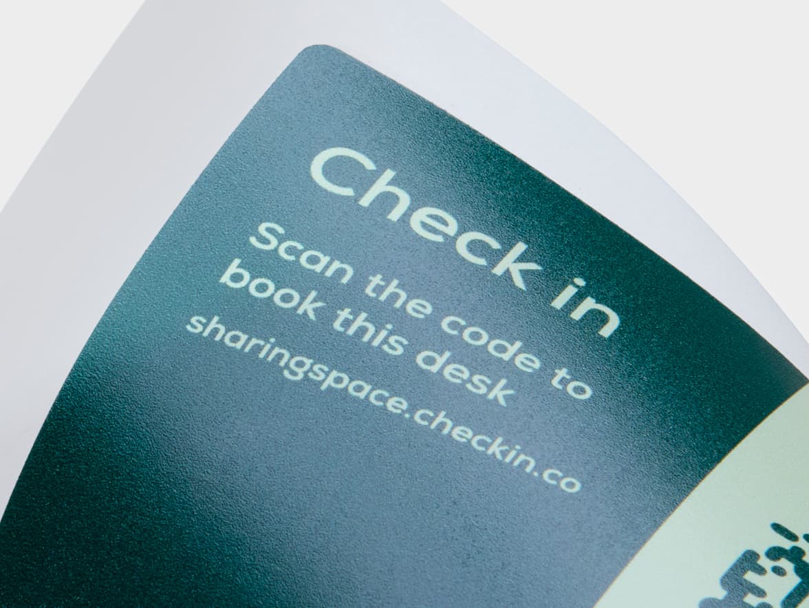 A detailed image of a rectangular coated sticker with dark and light green customization.