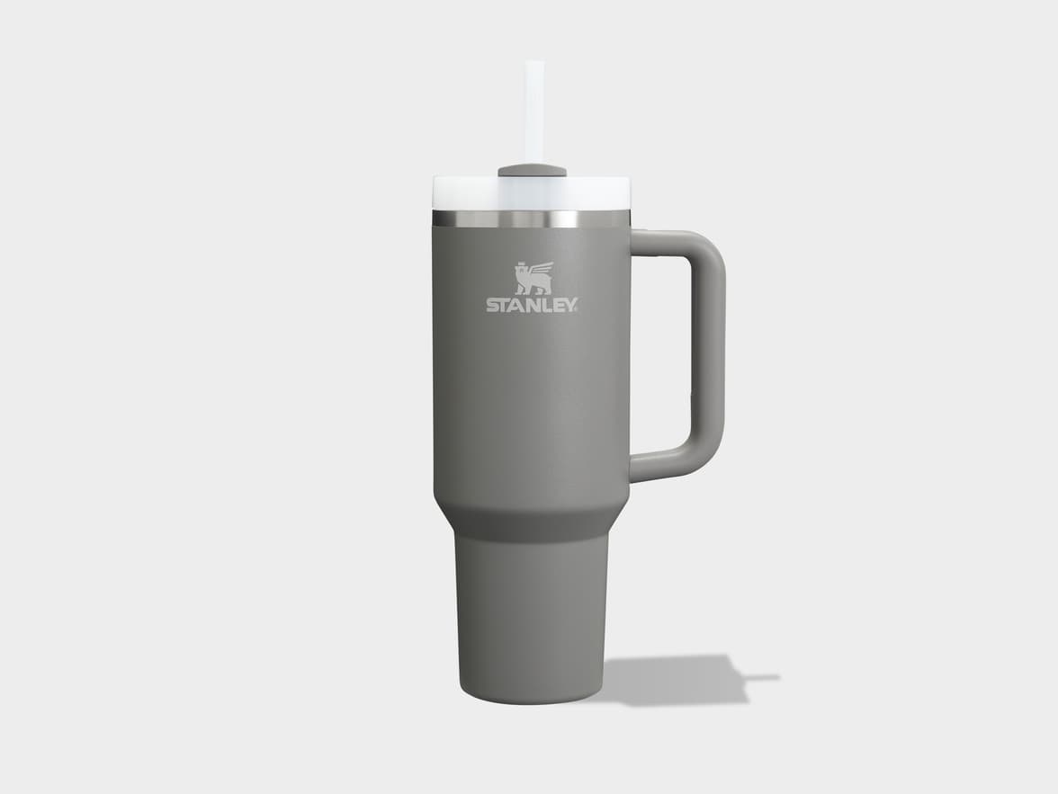 A grey Stanley tumbler with a handle, white lid, and straw.