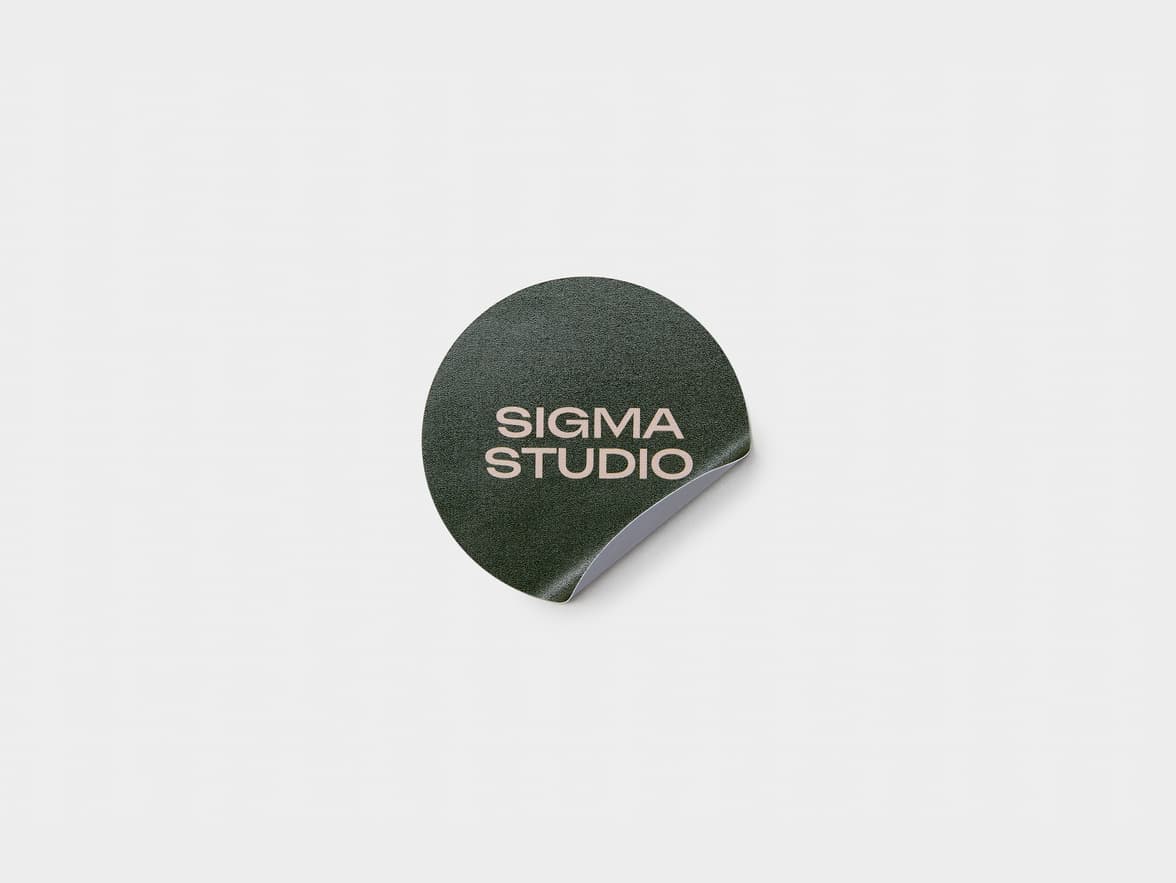A dark green customized round coated sticker.