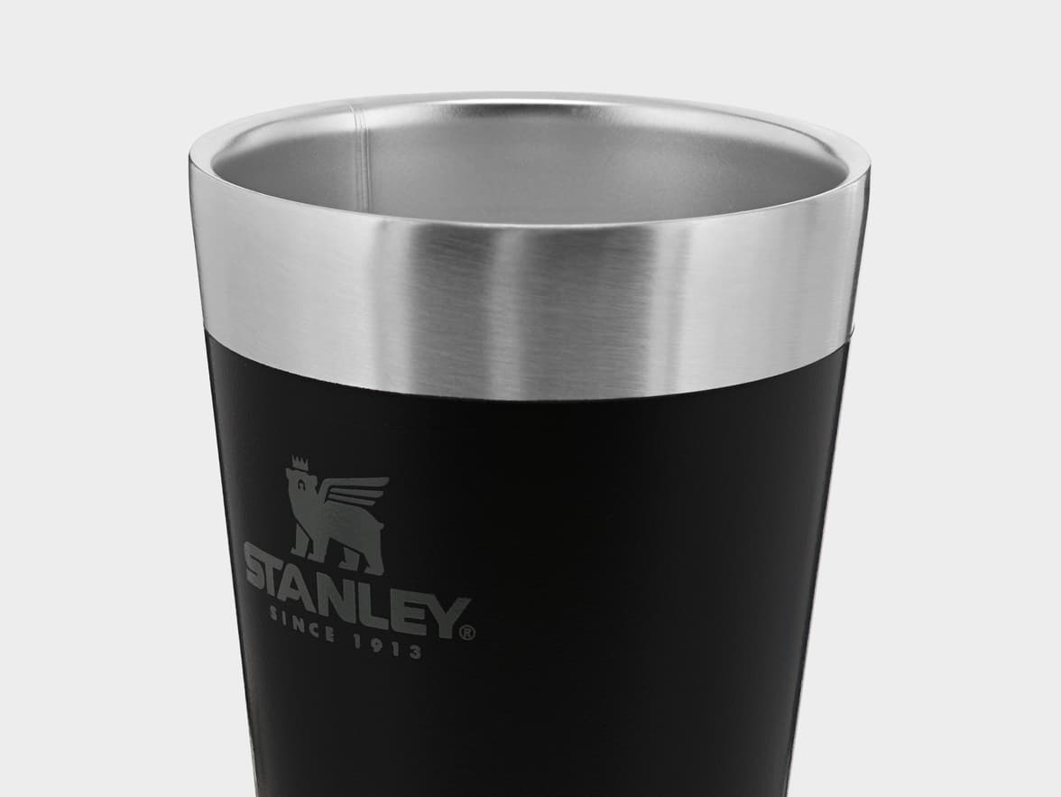 Black Stanley tumbler with a silver rim.