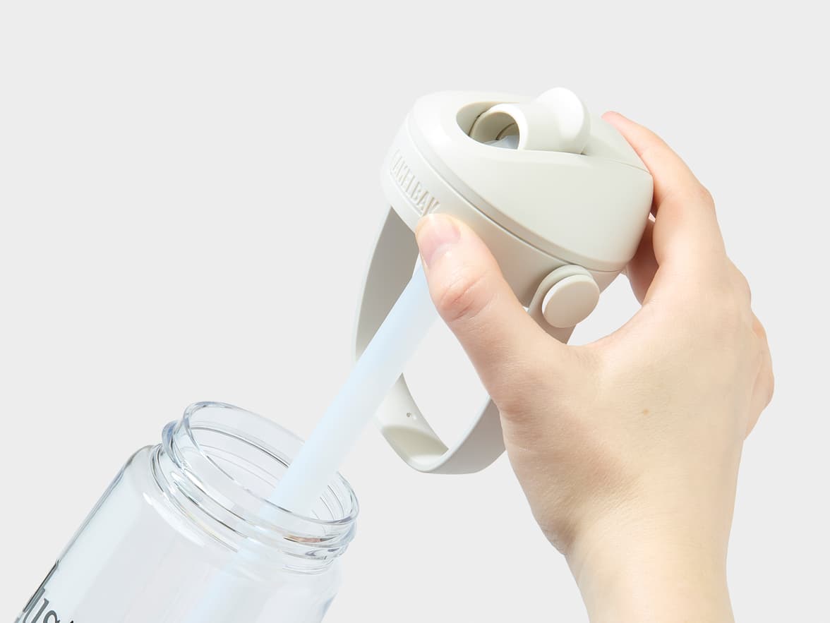 CamelBak water bottle being opened, showing a straw and 'Just Water' branding.