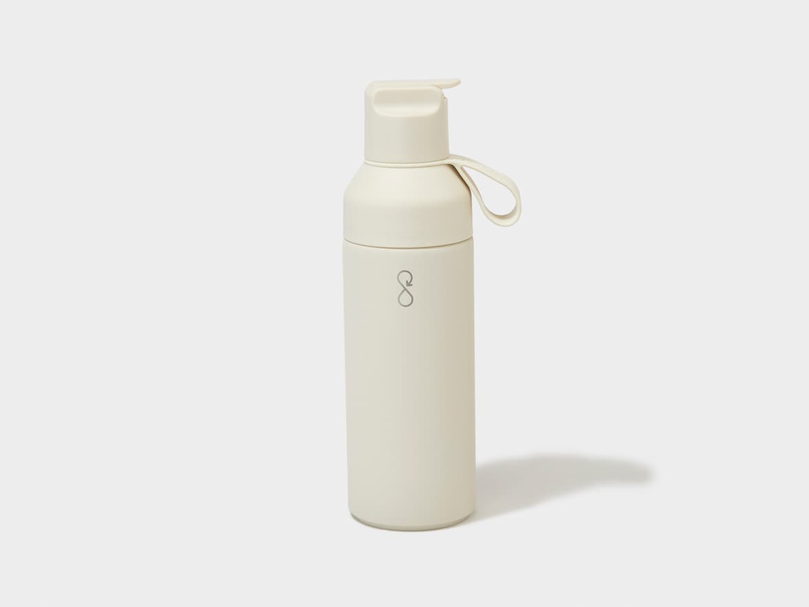 A light beige water bottle with a flip-top lid and an S-shaped circularity logo.